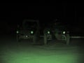 Night vision, military and vehicle in dark for army battle, target or enemy scan on battlefield or camp. Cars, transport Royalty Free Stock Photo