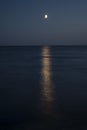 At night white moon over the sea with a reflection and a path. Royalty Free Stock Photo