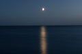 .At night a white moon over the sea with a reflection and a path At Royalty Free Stock Photo