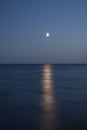 At night a white moon over the sea with a reflection Royalty Free Stock Photo