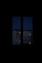 night window room view on the street with building lights atmospheric vertical picture with black frame space Royalty Free Stock Photo