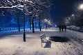 Night winter landscape in the alley with bench of city park Royalty Free Stock Photo