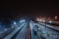 Night at the winter railway station. on the railway tracks there is a light trail from a passing train Royalty Free Stock Photo