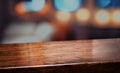 Nightclub background.Empty diagonal brown wooden table with blur bar restaurant bokeh lights,banner mockup template for display of