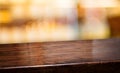 Nightclub background.Empty diagonal brown wooden table with blur bar restaurant bokeh lights,banner mockup template for display of