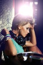 Nightclub, DJ and woman with headphones for listening to music with vinyl turntable and tech. Techno, rave and musician Royalty Free Stock Photo