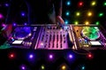 Nightclub DJ mixing decks at a house party, disco, rave or wedding