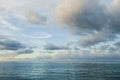 Nightfall over Caribbean sea. Deep ocean view with waves and white clouds. Relaxing seascape, endless sea, tropical waters