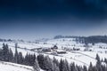 Nightime top view of remote village surrounded by snow