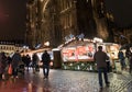 Nightime view of many people visiting the famous Christmas market in Strasbourg with the cathedral in the background