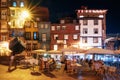 Nightlife on the crowded promenade of the Douro River with cafes and restaurants in Porto