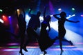 Nightlife and disco concept. Young people are dancing in club. Royalty Free Stock Photo