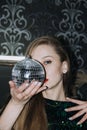 Nightlife, New year eve party, New year celebration. Portrait of young beautiful woman and disco ball