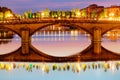 Nightlight over Ponte Santa Trinita and Arno river, seen from Ponte alla Carraia in Florence.