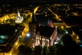 Nightly aerial view of Gothic church and Time Square in an old town in Europe