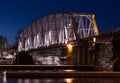 Nightly railroad bridge over stream in winter