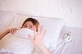 Nightmare or bad dream,Asian woman with fear and panic while lying down under the blanket in bedroom