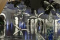 The nights view through a decorative glass door of inner courtyard of Sheikh Zayed Grand Mosque in Abu Dhabi city, United Arab Royalty Free Stock Photo