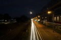 Nightscape car moving light trail long exposure photography in a city landscape during the night time with moon