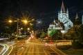 Nightscape church illuminated and car moving light trail long exposure photography in a city landscape