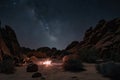 nighttime desert hike with stars and moon overhead, and distant point of light that could be a campfire