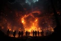 Nighttime forest fire, people\'s silhouettes watching Royalty Free Stock Photo