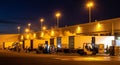 Nighttime Logistics: Forklifts and Trucks at a Warehouse Loading Dock Royalty Free Stock Photo