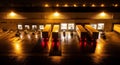 Nighttime logistics: Trucks, workers, and forklifts at a busy warehouse loading dock under bright lights Royalty Free Stock Photo