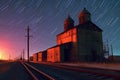 nighttime long exposure of grain elevator with star trails