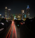 Nighttime long exposure shot of Atlanta skyline with car light traces