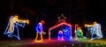 nighttime manger scene with baby Jesus, Mary, three wisemen and angel with trumpet