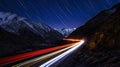 Nighttime Mountain Road with Star Trails and Light Trails Royalty Free Stock Photo