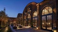 A nighttime shot of a converted train depot turned into a luxury hotel. The iconic arched windows and industrial details Royalty Free Stock Photo