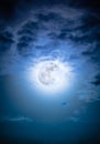 Nighttime sky with clouds and bright full moon with shiny. Royalty Free Stock Photo