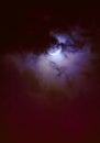 Nighttime sky with clouds and bright full moon with shiny.