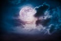 Nighttime sky with clouds and bright full moon with shiny.