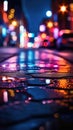 Nighttime street scene with cars and people walking along sidewalk. There are several cars parked on road, some of Royalty Free Stock Photo