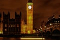 Nighttime view of Big Ben and Parliament with an illuminated bridge in London
