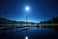 nighttime view of a lake with rods on the dock under bright moonlight Royalty Free Stock Photo