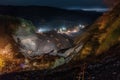 nighttime view of landslide with searchlights shining on the scene