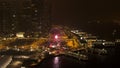 Singapore - 25 September 2018: A nighttime view of the pier, river, ferris wheel and beautiful night city. Stock. Purple