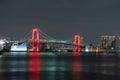 Nightview of Rainbow Bridge, illuminated in red as a sign of coronavirus alert Royalty Free Stock Photo