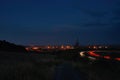 Nighty czech landscape with small path between fields in foreground and D8 highway leading to Chomutov city on 27th July 2018