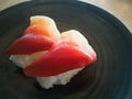 Nigiri hokkigai on black plate japanese food