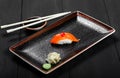 Nigiri with salmon on dark wooden background. Gunkan Sushi set. Japanese cuisine. Royalty Free Stock Photo