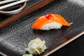 Nigiri with salmon on dark wooden background. Gunkan Sushi set. Japanese cuisine. Royalty Free Stock Photo