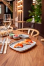 Nigiri set: salmon, shrimp, tuna on a plate on a table in a sushi bar