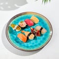 Nigiri sushi set on ceramic plate in minimal style. Nigiri sushi assorted with fish, crab, eel, tuna, shrimp, salmon and avocado. Royalty Free Stock Photo