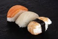 Nigiri sushi set, close-up on a black background. Fresh salmon, white fish, and shrimp Royalty Free Stock Photo