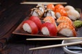 Nigiri sushi set served on clay plates with soy sauce and chopst Royalty Free Stock Photo